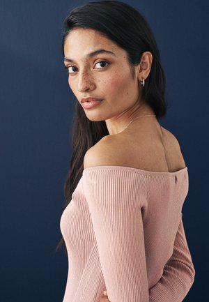 Rožinė raibuota off-shoulder suknelė su ilgomis rankovėmis, turinti mygtukų eilutę gale ir glotnia tekstūra prieš tamsų foną.