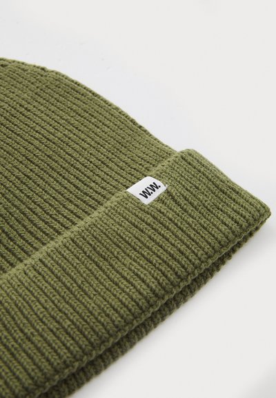 Green knitted beanie with ribbed texture and folded cuff, featuring a small white label with "WWW." on the side.