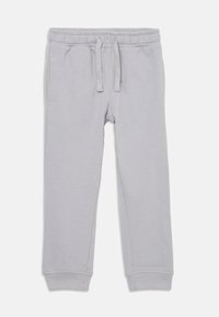 Lichtgrijze sweats met een elastische tailleband en trekkoord. Heeft zijzakken en cuffs aan de onderkant, gemaakt van een zachte stof.