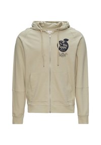 Sweat à capuche zippé beige avec un graphique d'une pomme et du texte à l'avant. Dispose d'une capuche, de poches kangourou et de poignets côtelés. Texture de tissu lisse.