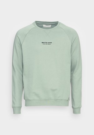 Lichtgroene sweatshirt met een geribde halslijn en manchetten. Heeft een zwart gedrukt logo met tekst gecentreerd op de borst. Zachte stofstructuur.