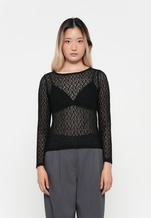 Black lace top with long sleeves, featuring a sheer design and a scalloped hem. The neckline is rounded, with a fitted silhouette.