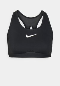 Μαύρο σπορ στηθόδεσμο με στρογγυλή λαιμόκοψη και σχέδιο racerback. Περιλαμβάνει λευκό λογότυπο Nike, λεπτομέρειες από δίχτυ και μαλακό υφασμάτινο σχέδιο.