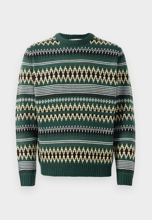 Grön stickad tröja med ett geometriskt mönster i gult, svart och vitt. Ribbad krage och manschetter. Vid passform och medelhårdhet.