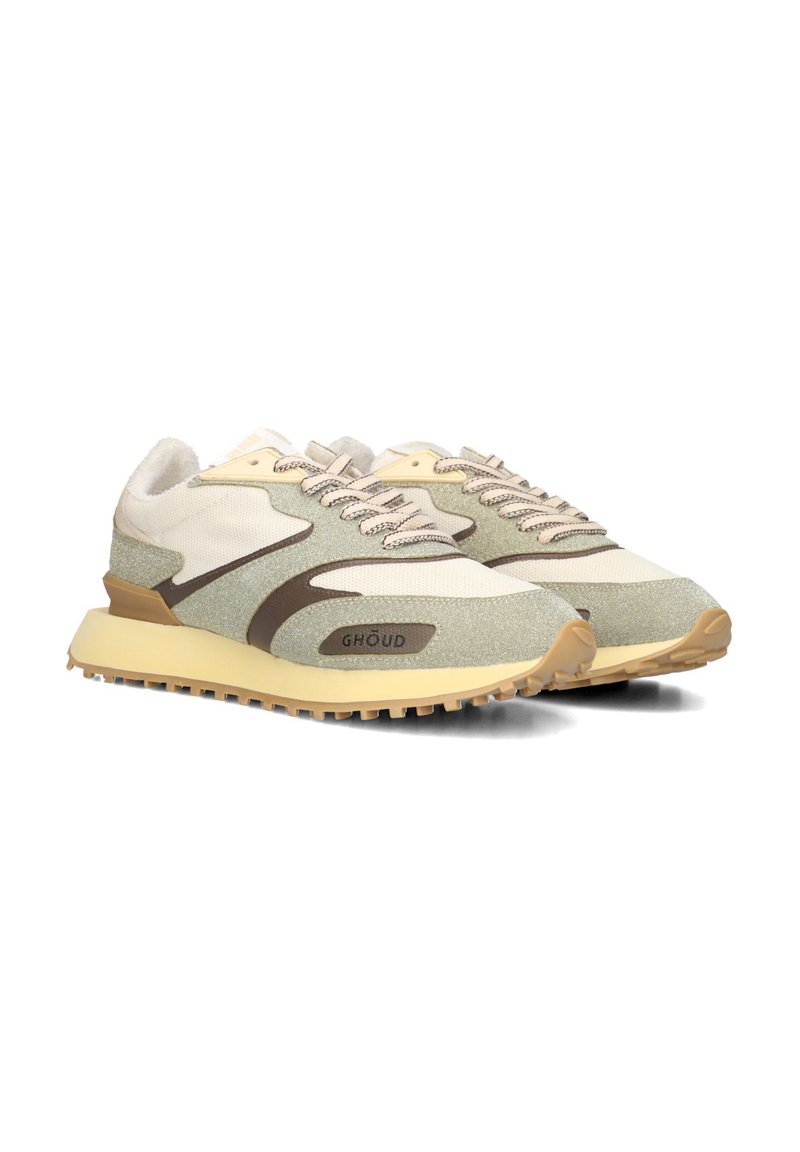 Sport sneakers with a blend of beige, green, and brown materials. Textured fabric, logo detail, and a contrasting rubber sole.