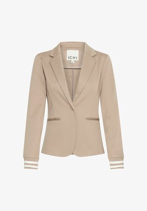 Beige blézer formázott fazonnal, csücskös gallérral, két elülső zsebbel és csíkos mandzsettával. Simább anyagból készült, minimális részletezéssel.