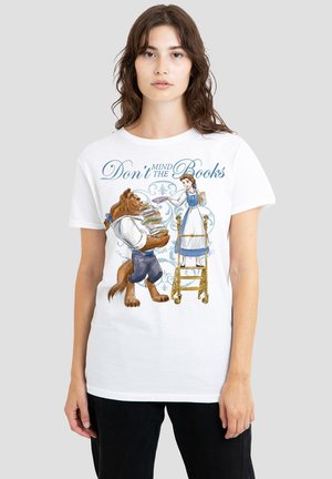 White cotton t-shirt featuring illustrated characters: a lion holding books and a woman beside a ladder, with text "Don't Mind the Books" above.