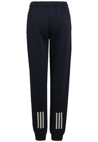 Navy cotton joggers with an elastic waistband. Features three white stripes on each ankle and a relaxed fit design.