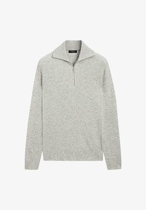 Grijze trui met opstaande kraag en een ritssluiting tot een kwart. Gemaakt van geribbelde stof, voorzien van lange mouwen en een aangesloten zoom.