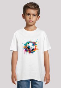 White cotton t-shirt featuring a colorful watercolor-style soccer ball design surrounded by splashes in blue, orange, and pink.