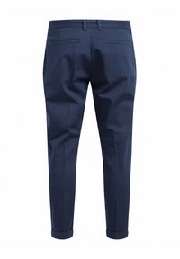 Navy blue trousers with a tapered design, made from smooth fabric. Features rolled cuffs and two back pockets with stitching accents.