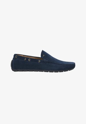 Bottines en suede bleu marine avec une semelle en caoutchouc, ornées d'œillets en or et de coutures sur les côtés pour le détail. Texture lisse.