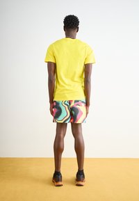 Nike Sportswear CLUB TEE - Navadna majica - yellow