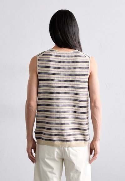 Knitted sleeveless top with horizontal stripes in cream, navy, and lavender. Ribbed neckline and hem. Soft texture, lightweight fabric.