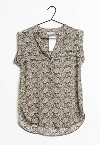 Top senza maniche con motivo in beige e nero. Presenta una scollatura a V, bottoni frontali e un orlo arrotondato. Il tessuto ha un design floreale.