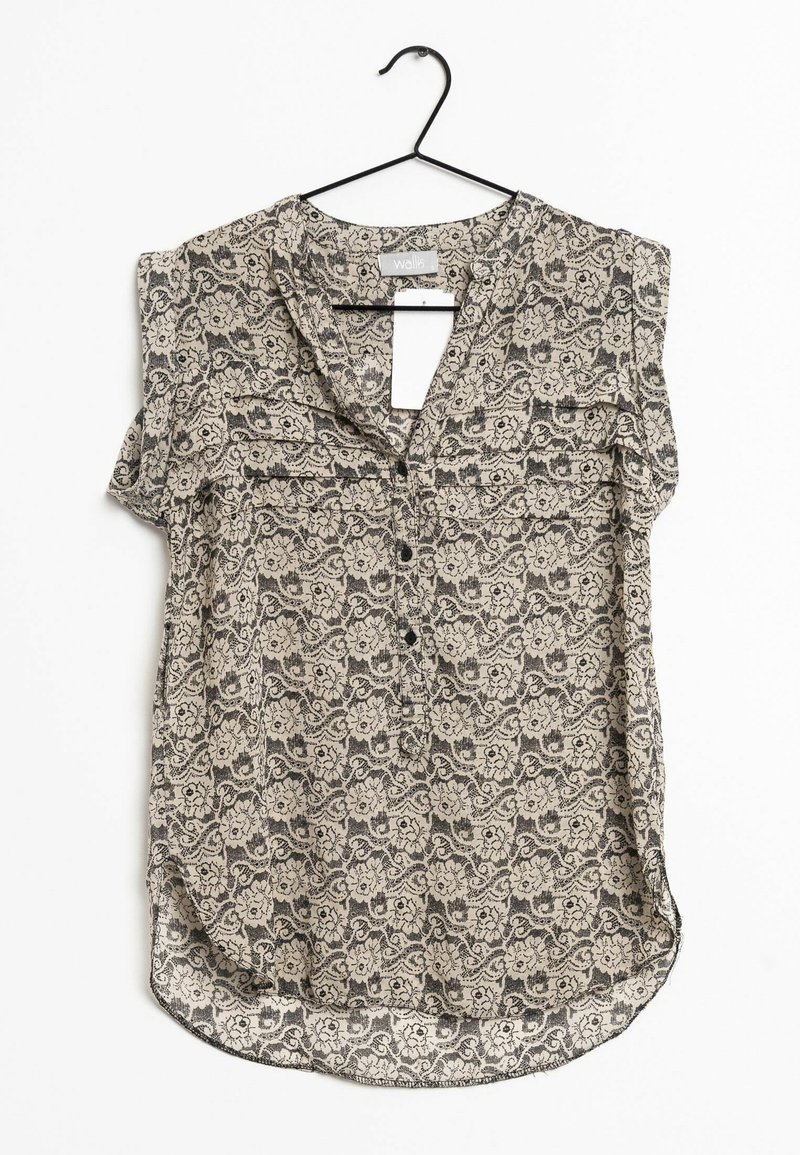 Top senza maniche con motivo in beige e nero. Presenta una scollatura a V, bottoni frontali e un orlo arrotondato. Il tessuto ha un design floreale.