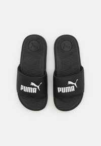 Sorte slidesandaler med en tekstureret gummisål, der har en bred strop med hvid "PUMA" branding og logo på overfladen.