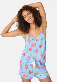 Blue pajama set featuring a camisole and shorts, both adorned with a red strawberry pattern and green leaves. Hypoallergenic fabric, relaxed fit.