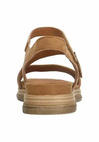 Brown suede sandals with a multiple strap design, stitched detailing, and a textured light brown sole. Adjustable back strap with hardware accent.