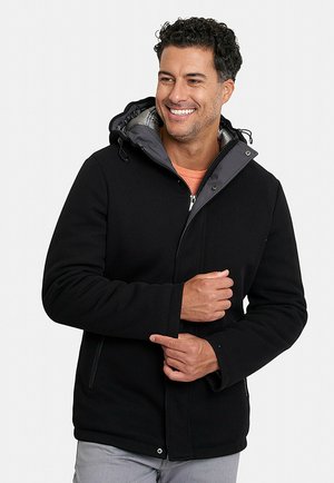 Chaqueta con capucha negra y un interior gris, presenta un cierre de cremallera, bolsillos laterales y costuras visibles, diseñada para brindar calidez y comodidad.