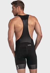 Schwarze Radtrikots mit strukturiertem Netzrücken, elastischen Beinbündchen und dezenten Logodetails. Entworfen für Komfort und Leistung.