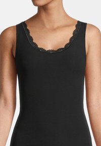 Black ribbed tank top featuring a scalloped lace trim around the neckline. Classic fit with a soft, stretchy texture.