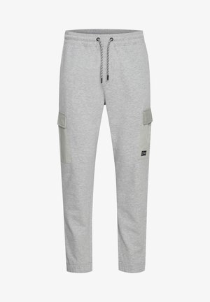 Helle graue Jogginghosen aus weichem Stoff. Mit Kordelzugbund und zwei großen Seitentaschen mit einem kontrastierenden grünen Akzent.