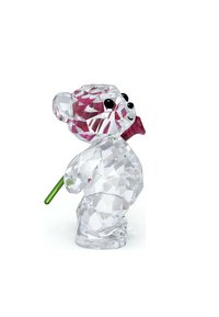 Przezroczysta figurka misia z kryształu z zielonym łodygą i akcentem fioletowego kwiatu, posiadająca fasetowy wzór i czarne oczy.