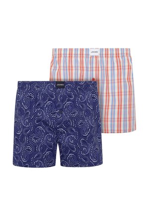 Two pairs of Jockey boxer shorts, one navy with white paisley pattern, one white with orange and blue checkered pattern.