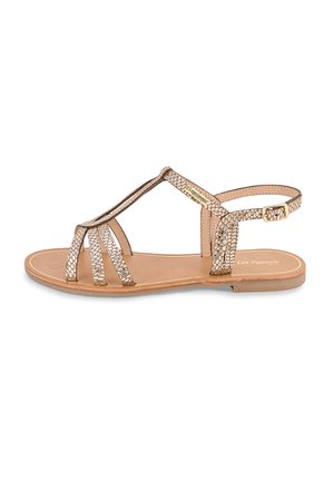 Bronze metallic sandals with reptile-texture straps, a closed toe design, and a flat sole. Buckle closure at the ankle with a tan footbed.