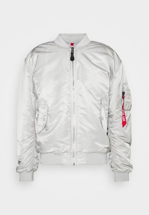 Silver bomber jacket with ribbed cuffs and collar, zip closure, side pockets, and a utility pocket featuring a red fabric tag. Smooth texture.