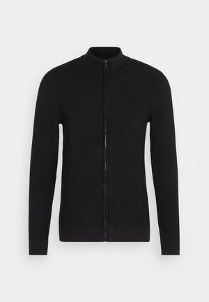 Schwarzer Zip-Hoodie mit Stehkragen. Hergestellt aus strukturiertem Strickmaterial. Lange Ärmel und gerader Schnitt mit gerippten Bündchen und Saum.