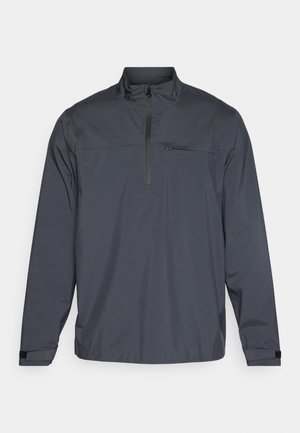 Dunkelgrauer Pullover-Jacke mit einem Viertel-Reißverschluss, einschließlich einer Fronttasche und Klettverschluss-Manschetten, aus glattem, leichtem Stoff.