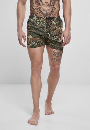 Bañador de camuflaje con cinturilla elástica, de corte corto y una mezcla de patrones en verde, marrón y negro.