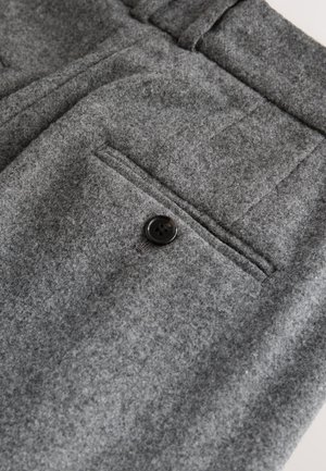 Gray wool trousers featuring a flat front, a single back pocket with a black button, and a soft, textured finish.