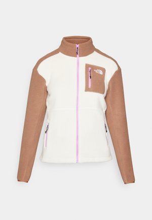 Fleece jacket with white body and brown sleeves, high collar, front zipper, and a small chest pocket with a pink zipper. Features logo.