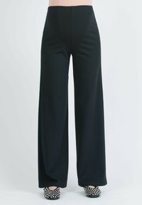 Black wide-leg trousers with a high waist and smooth texture. Paired with polka dot flats, featuring a round toe and ankle opening.