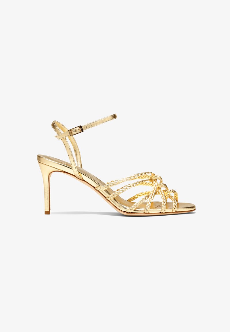 Gold high-heeled sandals feature braided straps, an adjustable ankle strap, and a sleek design with a shiny metallic finish.