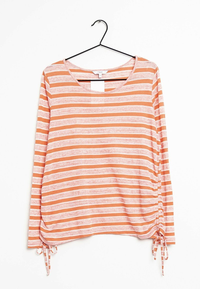 Haut à manches longues avec des rayures horizontales orange et blanches. Il possède un col rond et des liens sur les côtés. Tissu doux avec une coupe décontractée.