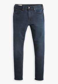 Mörkblå denimjeans med slim fit, som har fem fickor, dragkedja och en subtil sliten textur vid låren.
