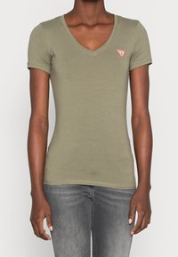 Olive green fitted t-shirt with a V-neck, short sleeves, and a small red triangle logo on the left chest. Made of soft, smooth fabric.