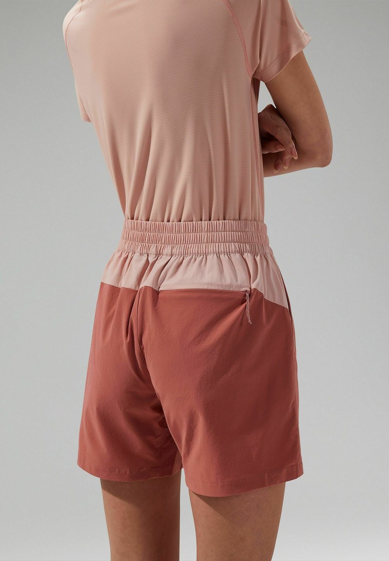 Shorts met een elastische tailleband, in koraal met een lichtere bovenkant, voorzien van een ritssluitingzak aan de zijkant en gemaakt van een soepele, lichte stof.