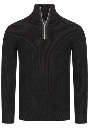 Pull en maille noire avec un col montant et une courte fermeture éclair. Présente une texture côtelée et des manches longues. Accentué par un petit logo.