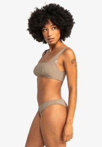 Light brown ribbed bikini set featuring a square neckline and wide straps. The texture is smooth, and the bottoms have a classic cut.