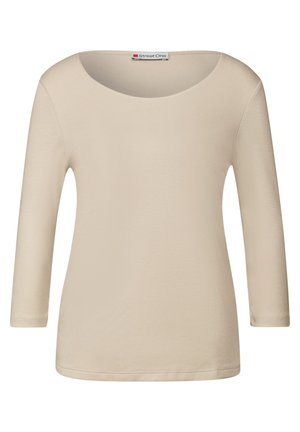 Beige lange mouwtop met een ronde halslijn. Gemaakt van een gladde, rekbare stof. Heeft een eenvoudig ontwerp en een rechte zoom.