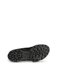 Black athletic shoe sole with a textured surface, featuring multi-directional lugs for traction and a smooth, curved edge.