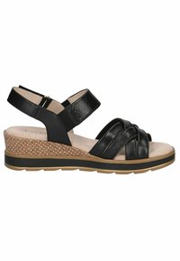 Sandalias de cuña de cuero negro con tiras cruzadas, plantilla acolchada y suela media de corcho texturizado. Cuenta con una correa ajustable en el tobillo y suela de goma.