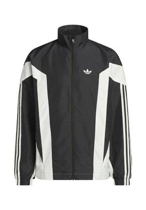 Zwart-witte ritsjack gemaakt van lichtgewicht stof, met een hoge kraag, hoekige kleurblokken en drie strepen op elke mouw.