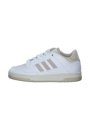 White sneakers with beige accents, a textured rubber sole, rounded toe, and three signature stripes on the side; lace-up design.