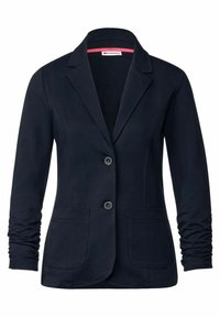 Námořnický modrý blazer s klopovým límcem, dvěma předními kapsami a dvěma knoflíky. Vyroben z hladké tkaniny s mírně řasenými rukávy.